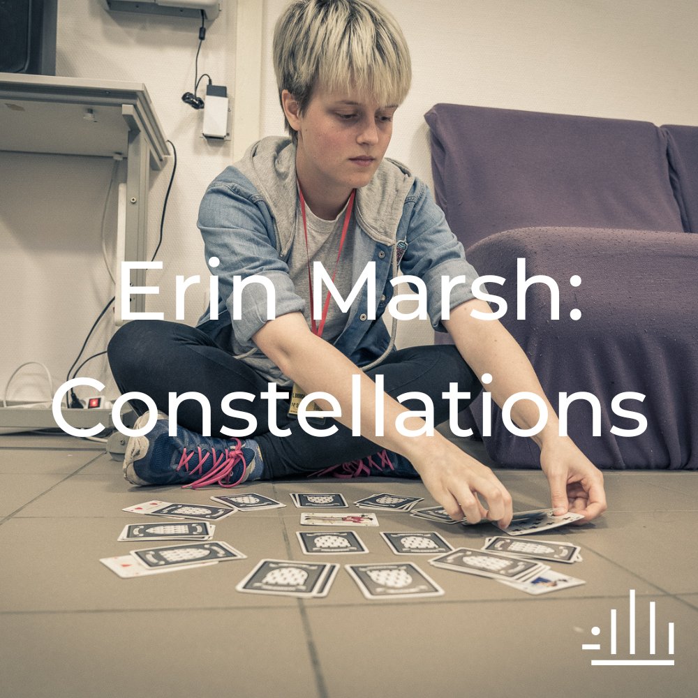 Erin sits on the floor, playing clock patience with a pack of cards. Text reads: Erin Marsh: Constellations